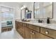 This bathroom offers dual sinks, granite countertops, wood cabinets, and a separate area for the shower at 306 Autumn Azalea Way, Summerville, SC 29486
