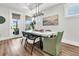 Elegant dining room with stylish chairs, a modern light fixture, and a view to the outdoors at 306 Autumn Azalea Way, Summerville, SC 29486