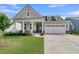 Beautiful single-Gathering home with a manicured lawn and inviting front porch during the day at 306 Autumn Azalea Way, Summerville, SC 29486