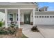 Inviting home with charming front porch, neat landscaping, and a two-car garage during the day at 306 Autumn Azalea Way, Summerville, SC 29486