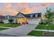 Beautiful single-Gathering home with a manicured lawn and inviting front porch, at sunset at 306 Autumn Azalea Way, Summerville, SC 29486