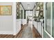 Charming hallway with hardwood floors, stylish wallpaper, and elegant console table with decor at 306 Autumn Azalea Way, Summerville, SC 29486
