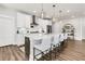 A bright kitchen with stainless steel appliances, large center island, and stylish pendant lighting at 306 Autumn Azalea Way, Summerville, SC 29486