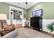 Cozy living room with comfortable seating, a modern cabinet, and a view into the stylish entry hall at 306 Autumn Azalea Way, Summerville, SC 29486