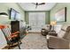 Inviting living room with stylish decor, comfortable armchairs, and a large window for natural light at 306 Autumn Azalea Way, Summerville, SC 29486