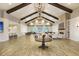 Spacious lounge featuring wood beam ceilings, a cozy fireplace, and ample seating for relaxation and socializing at 306 Autumn Azalea Way, Summerville, SC 29486