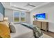 This main bedroom features a decorative ceiling, white walls, wood floors, and a dresser with a TV at 306 Autumn Azalea Way, Summerville, SC 29486