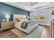 A serene bedroom features an accent wall, a large bed with decorative pillows, and lots of natural light at 306 Autumn Azalea Way, Summerville, SC 29486