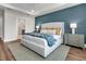 A peaceful main bedroom boasts an ensuite bathroom, accent wall, and a cozy atmosphere at 306 Autumn Azalea Way, Summerville, SC 29486