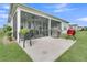 A screened patio features dual grills and a view into the home through glass doors and windows at 306 Autumn Azalea Way, Summerville, SC 29486