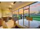 Inviting screened patio featuring comfortable seating, ceiling fans, and a beautiful view of the sunset at 306 Autumn Azalea Way, Summerville, SC 29486