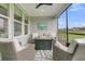 Cozy screened-in patio with a fire table and wicker chairs at 306 Autumn Azalea Way, Summerville, SC 29486