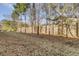 Large, wooded backyard with a privacy fence at 3066 Emma Ln, Mount Pleasant, SC 29466