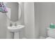 Powder room with pedestal sink, round mirror, modern fixtures, and a comfort height toilet at 3066 Emma Ln, Mount Pleasant, SC 29466