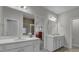 Bright bathroom featuring double sinks, white cabinetry, quartz countertops, and tiled shower at 3066 Emma Ln, Mount Pleasant, SC 29466