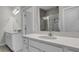 Bright bathroom featuring quartz countertops, white cabinetry, and tiled shower in background at 3066 Emma Ln, Mount Pleasant, SC 29466