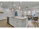 Open-concept kitchen with a center island seamlessly connects to the living area, filled with natural light at 3066 Emma Ln, Mount Pleasant, SC 29466