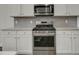 This modern kitchen is equipped with stainless steel appliances and bright white cabinets, ensuring efficient cooking at 3066 Emma Ln, Mount Pleasant, SC 29466