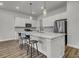 Bright kitchen featuring white cabinetry, stainless steel appliances, and a spacious center island with seating at 3066 Emma Ln, Mount Pleasant, SC 29466