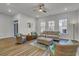 Spacious living room featuring wood floors, ceiling fan, neutral walls, and multiple windows for natural light at 3066 Emma Ln, Mount Pleasant, SC 29466