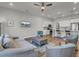 Open living room with wood floors, ceiling fan, neutral walls, and views into the kitchen area at 3066 Emma Ln, Mount Pleasant, SC 29466
