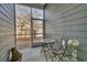 Cozy screened patio with a charming table, chairs, and views of the wooded backyard at 3066 Emma Ln, Mount Pleasant, SC 29466
