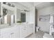Bright bathroom featuring double vanity, travertine tile floors, large mirror and modern fixtures at 33 Calhoun St # 218, Charleston, SC 29401