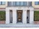 Elegant building entrance featuring stately columns and planters, accentuating architectural detail at 33 Calhoun St # 218, Charleston, SC 29401