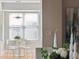 Bright dining area featuring a modern table set, large windows, and neutral tones at 33 Calhoun St # 218, Charleston, SC 29401