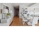 Dining area with a glossy white table, modern chairs, and a stylish bookshelf for decor at 33 Calhoun St # 218, Charleston, SC 29401
