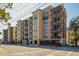 Beautiful view of a multi-story building featuring brick and beige siding with multiple balconies at 33 Calhoun St # 218, Charleston, SC 29401