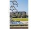 View of the building behind a decorative bird fountain in a landscaped park setting at 33 Calhoun St # 218, Charleston, SC 29401