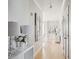 Hallway with wood floors, white trim, decorative lamps, and access to multiple rooms at 33 Calhoun St # 218, Charleston, SC 29401
