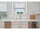 Modern kitchen with stainless steel appliances, white cabinets, and views out the window at 33 Calhoun St # 218, Charleston, SC 29401