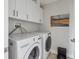 Well-equipped laundry room with modern LG washer and dryer, complemented by white cabinetry for ample storage at 33 Calhoun St # 218, Charleston, SC 29401