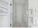 Modern shower with glass door, white tile, and stainless steel fixtures at 33 Calhoun St # 218, Charleston, SC 29401