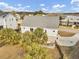 Aerial view showcasing the backyard with palm trees, a patio area, and a secure fenced perimeter at 4258 Jacobs Pt Ct, Ravenel, SC 29470