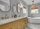 Stylish bathroom featuring dual sinks, a soaking tub, modern fixtures, and a large window for natural light at 4258 Jacobs Pt Ct, Ravenel, SC 29470