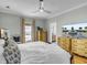 Tranquil bedroom with a king bed, dresser, flat screen TV, and connecting bathroom with dual sinks at 4258 Jacobs Pt Ct, Ravenel, SC 29470