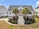 Inviting coastal home with grand staircase, a welcoming porch, lush landscaping and a delightful curb appeal at 4258 Jacobs Pt Ct, Ravenel, SC 29470