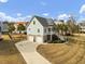 Charming coastal home featuring a two-car garage, a welcoming front porch, and landscaped surroundings at 4258 Jacobs Pt Ct, Ravenel, SC 29470