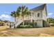 Exterior shot of a light blue two-story house with a large front porch and landscaped front yard at 4258 Jacobs Pt Ct, Ravenel, SC 29470