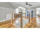 Modern hallway with hardwood floors, a wooden railing, and natural light at 4258 Jacobs Pt Ct, Ravenel, SC 29470