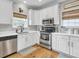Cozy kitchen boasts white cabinets, stainless steel appliances, and a stylish faucet at 4258 Jacobs Pt Ct, Ravenel, SC 29470