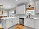 Modern kitchen featuring sleek white cabinets, stainless steel appliances, and a view to the dining room at 4258 Jacobs Pt Ct, Ravenel, SC 29470