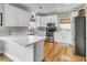 Bright kitchen featuring white cabinets, stainless steel appliances, and hardwood floors at 4258 Jacobs Pt Ct, Ravenel, SC 29470