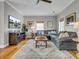 Comfortable living room featuring a large sofa, wood floors, and plenty of natural light at 4258 Jacobs Pt Ct, Ravenel, SC 29470
