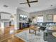 Bright living room with hardwood floors, large sofa, and ceiling fan at 4258 Jacobs Pt Ct, Ravenel, SC 29470