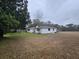 Expansive backyard with a white home featuring a brick chimney and covered car port at 488 Society Rd # A&B, McClellanville, SC 29458