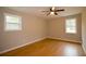 Bright bedroom with hardwood floors, ceiling fan, and windows offering plenty of natural light at 488 Society Rd # A&B, McClellanville, SC 29458